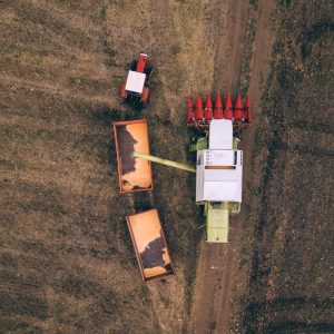 aerial-view-of-combine-pouring-harvested-corn-grai-compressed